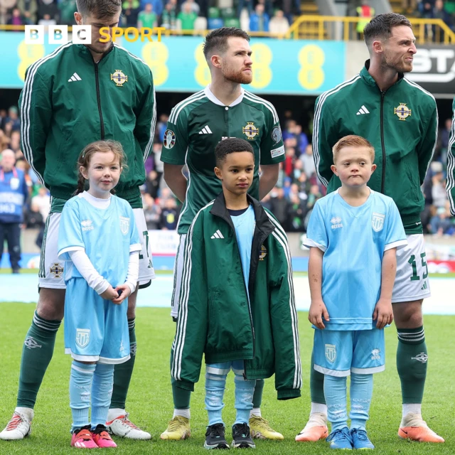 Northern Ireland’s Paul Smyth gives a mascot his jacket