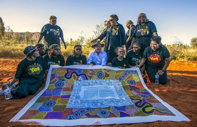 Prime Minister Albanese with Aboriginal leaders holding a copy of the Uluru Statement from the Heart in central Australia last week