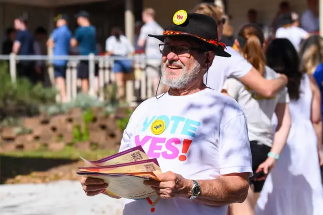 A vote Yes volunteer is seen at a voting centre in Brisbane, Australia, 14 October 2023.