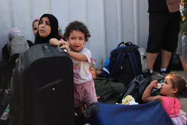 Palestinians with foreign passports wait at the Rafah gate hoping to cross into Egypt - 14 October 2023