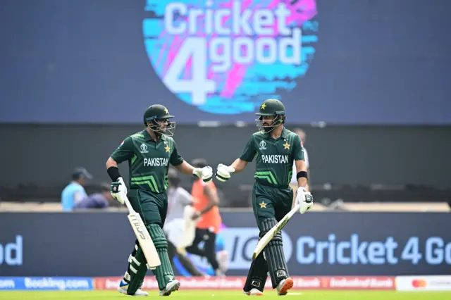 Pakistan's Imam-ul-Haq (L) and Abdullah Shafique arrive to bat during the 2023 ICC Men's Cricket World Cup one-day international (ODI) match between India and Pakistan at the Narendra Modi Stadium in Ahmedabad