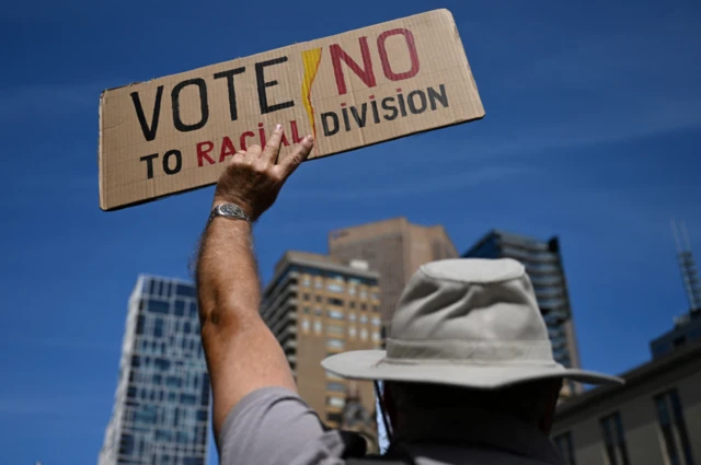 A person holds up a "Vote No" placard at a rally against the Voice referendum in Melbourne, Australia September 23, 2023.