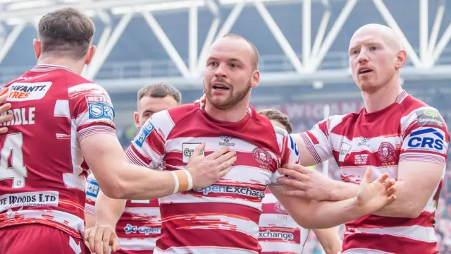 Liam Marshall (centre) celebrates a try for Wigan