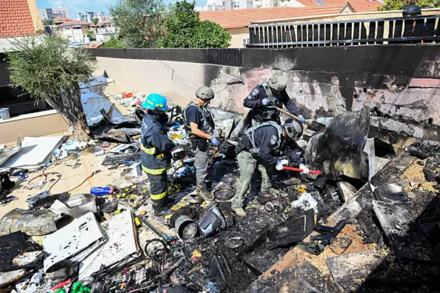 Firefighters and security forces extinguish a fire after a rocket fired from Gaza exploded on a house in Sderot, Israel.