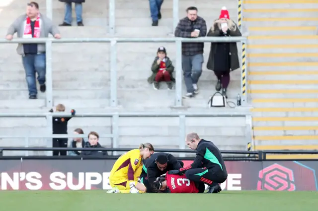 Gabby George is comforted by Mary Earps as physios tend to her.