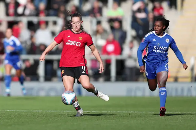 Maya Le Tissier of Manchester United runs with the ball from Deanne Rose