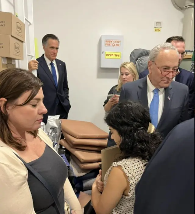 Senators Mitt Romney and Chuck Schumer in the shelter