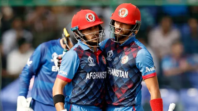 Rahmanullah Gurbaz and Ibrahim Zadran hug as the former reaches his half-century