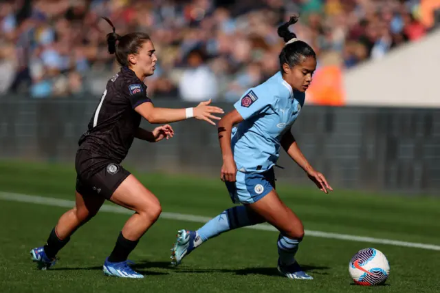 Jamie-Lee Napier of Bristol City battles for possession with Mary Fowler