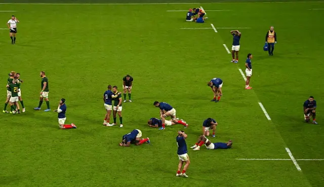 France players lay on the field dejected after the game