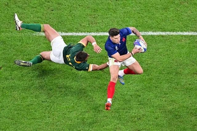 France's wing Damian Penaud is tackled by South Africa's fly-half Handre Pollard