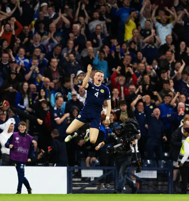 Scott McTominay jumping high into the Hampden air