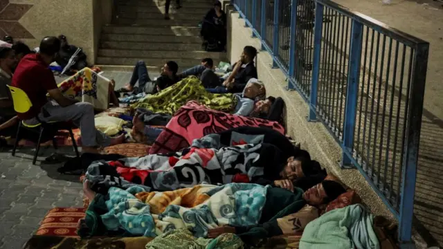 Palestinians, who fled their houses amid Israeli strikes, shelter at a United Nations-run school,