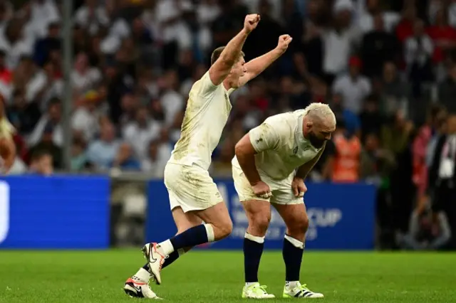 Owen Farrell with his arms aloft