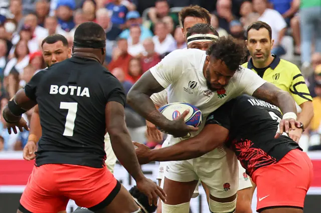 England's blindside flanker Courtney Lawes is tackled by Fiji's hooker Tevita Ikanivere