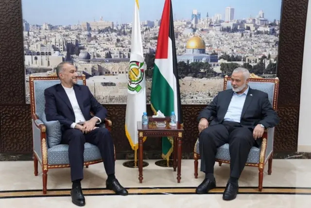 Hossein Amir-Abdollahian sitting down at a meeting with Ismail Haniyeh