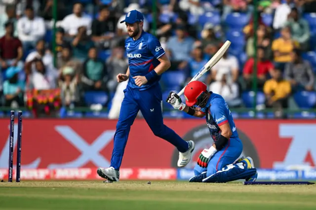 Afghanistan's Rahmanullah Gurbaz (R) reacts after his dismissal during the 2023 ICC Men's Cricket World Cup one-day international (ODI) match between England and Afghanistan at the Arun Jaitley Stadium in New Delhi