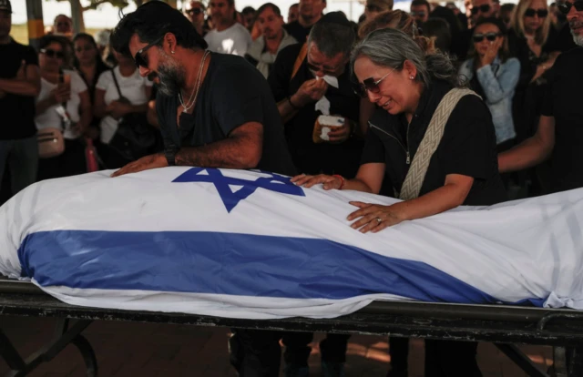 Family members and relatives mourn at the funeral of Antonio Macias who was killed during the Hamas attack on a music festival which killed more than 260 people near Raim last week