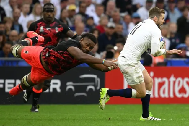 England's left wing Elliot Daly is tackled by Fiji's number eight Viliame Mata