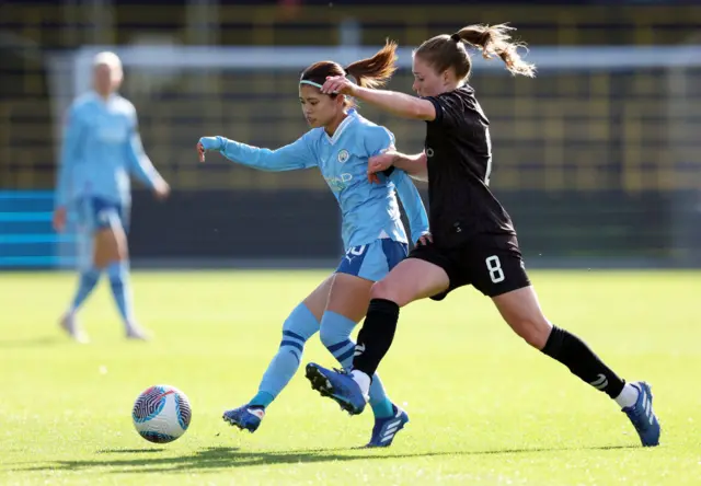 Yui Hasegawa of Manchester City is challenged by Amy Rodgers