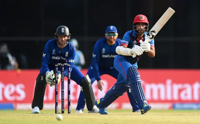 Hashmatullah Shahidi of Afghanistan plays a shot as Jos Buttler of England keeps during the ICC Men's Cricket World Cup India 2023 between England and Afghanistan