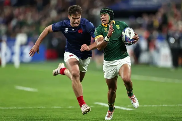 South Africa's wing Cheslin Kolbe runs in ahead of France's wing Damian Penaud