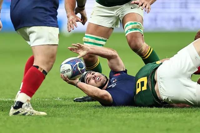 France's scrum-half and captain Antoine Dupont passes the bal