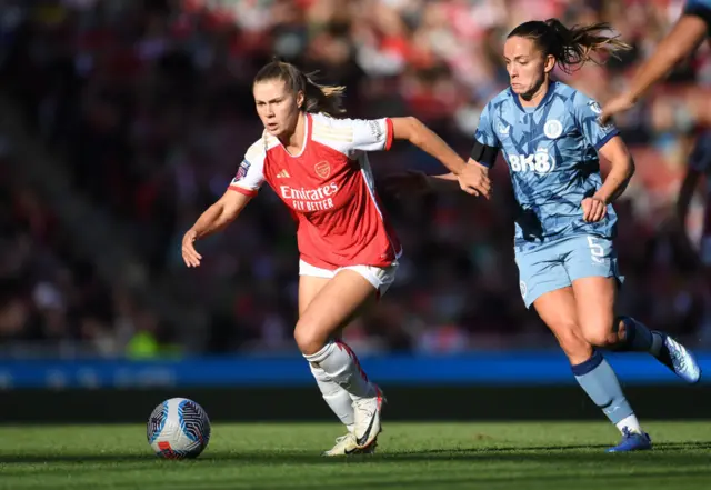 Victoria Pelova of Arsenal is challenged by Lucy Staniforth