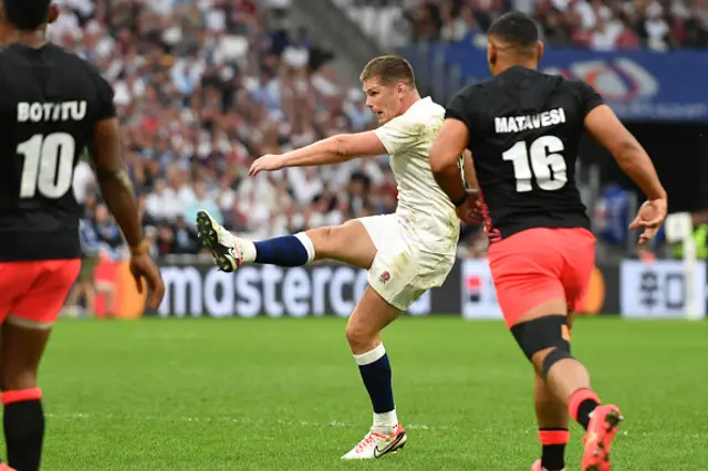 Owen Farrell drop kicks the ball