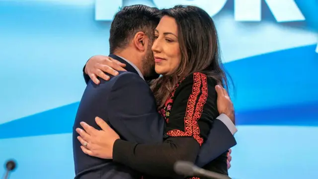 irst Minister and SNP leader Humza Yousaf embraces his wife councillor Nadia El-Nakla after she spoke on an emergency motion on Israel-Palestine during the SNP annual conference