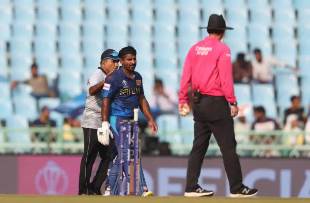 Kusal Perera receives a medical check for concussion