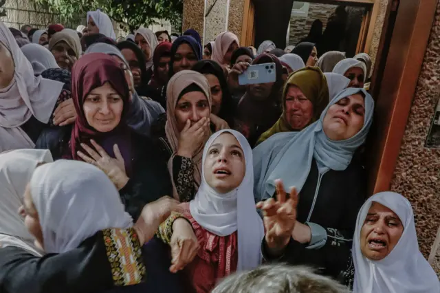 Women seen mourning during the funeral of a Palestinian youth killed in clashes witih Israeli forces