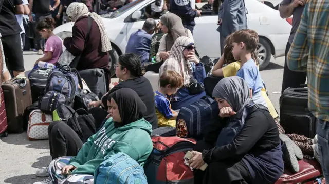 Palestinians with dual nationalities wait to cross the Rafah border crossing with Egypt, southern Gaza Strip