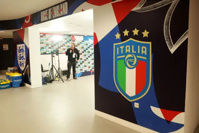 The tunnel at Wembley with the England and Italy crests either side.