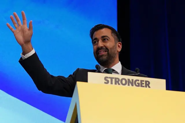 Humza Yousaf smiling and waving