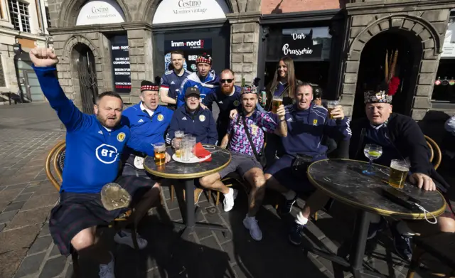 Scotland fans enjoy some refreshments in downtown Lille