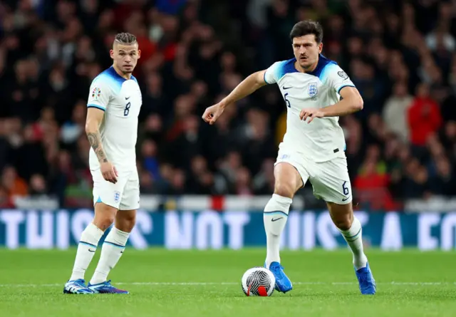 Harry Maguire dribbles the ball out of defence.