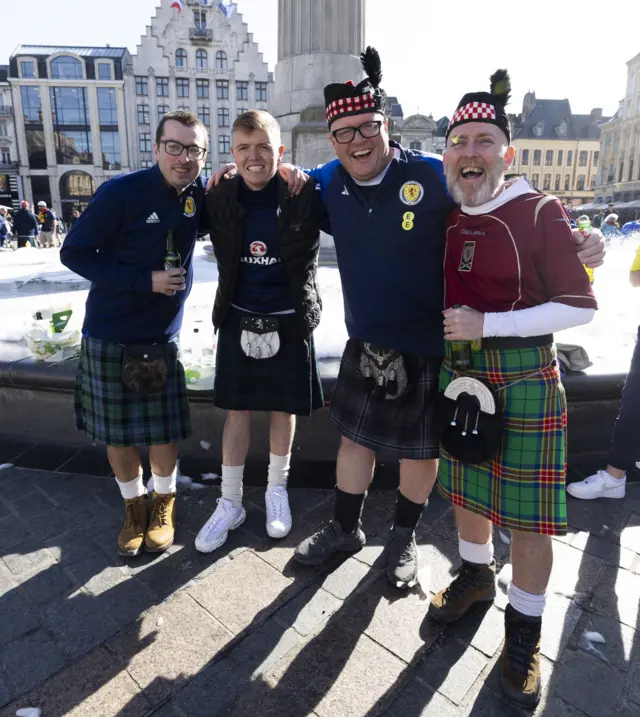 Kilted Scotland fans enjoy the Lille sunshine