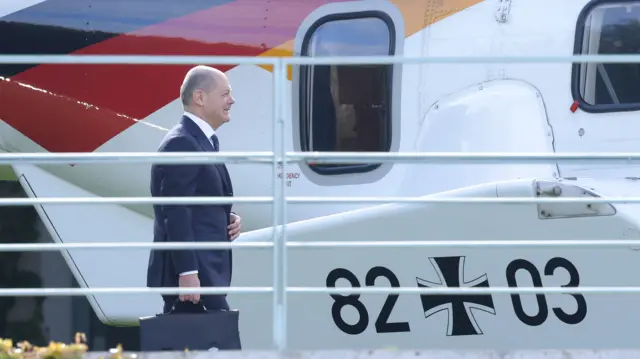 German Chancellor Olaf Scholz prepares to board a helicopter at the Chancellery to depart for Israel on October 17, 2023 in Berlin, Germany