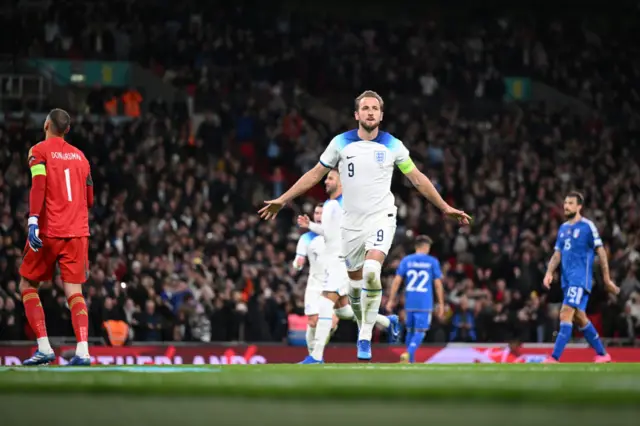 Kane celebrates scoring for England.