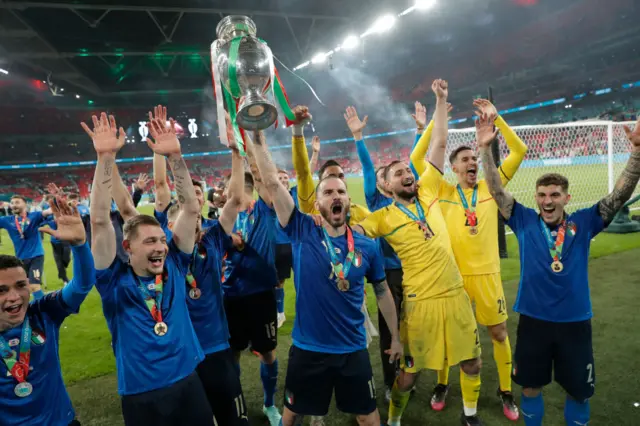 Italy defender Leonardo Bonucci lifts the Euros trophy in front of the Italy fans at Wembley.