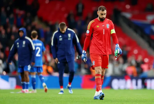 Donnarumma trudges to applaud the travelling fans at full time.