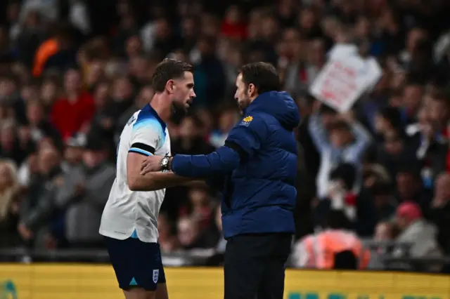 Henderson and Southgate shake hands on the touchline.