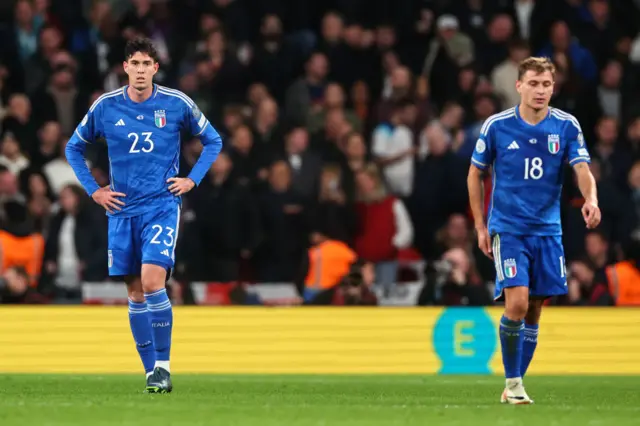 Barella and Bastoni trudge back to kick off after the third England goal.