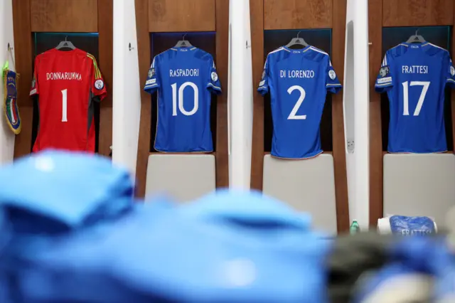 Italy shirts hang ready in the dressing room before the game.