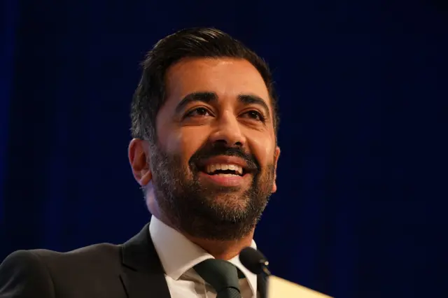 Headshot of Humza Yousaf smiling