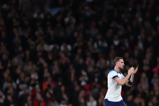 Henderson claps the fans as he walks off the pitch.