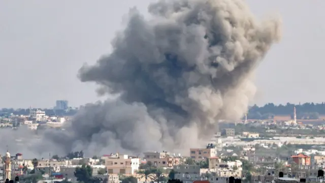 Smoke plumes billow after an explosion during Israeli bombardment in Rafah in the southern Gaza Strip - 18 October 2023