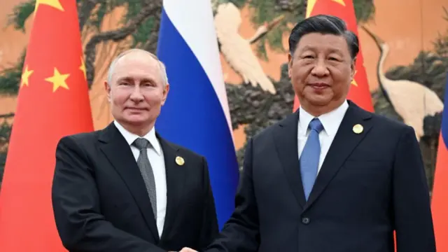 Xi and Putin shake hands before the bilateral meeting