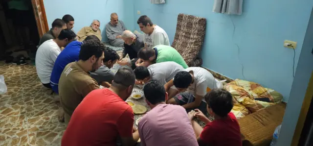 People share a meal inside the house